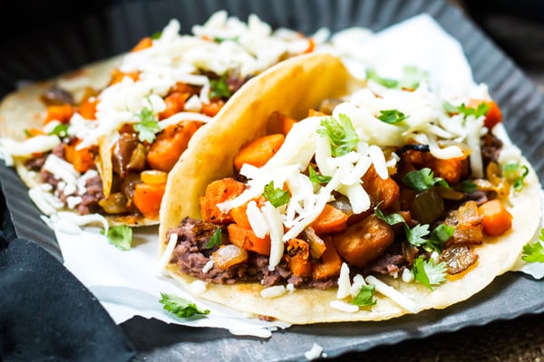 A picture of sweet potato black bean tacos topped with cheese for an easy lunch.