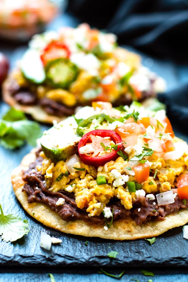 Super Quick Breakfast Tostadas with Eggs RECIPE served with cilantro and jalapenos.
