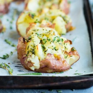 Ultra Crispy Smashed Potatoes with Garlic + Herbs - Evolving Table