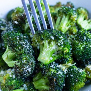 Lemon garlic air fryer broccoli is eaten with a fork.