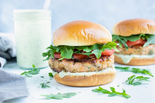 The Best Salmon Burgers with Avocado Ranch - Evolving Table