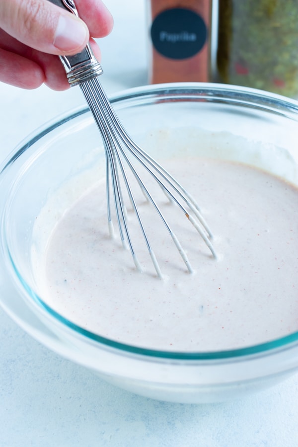 Creamy thousand island dressing is made in a glass bowl.