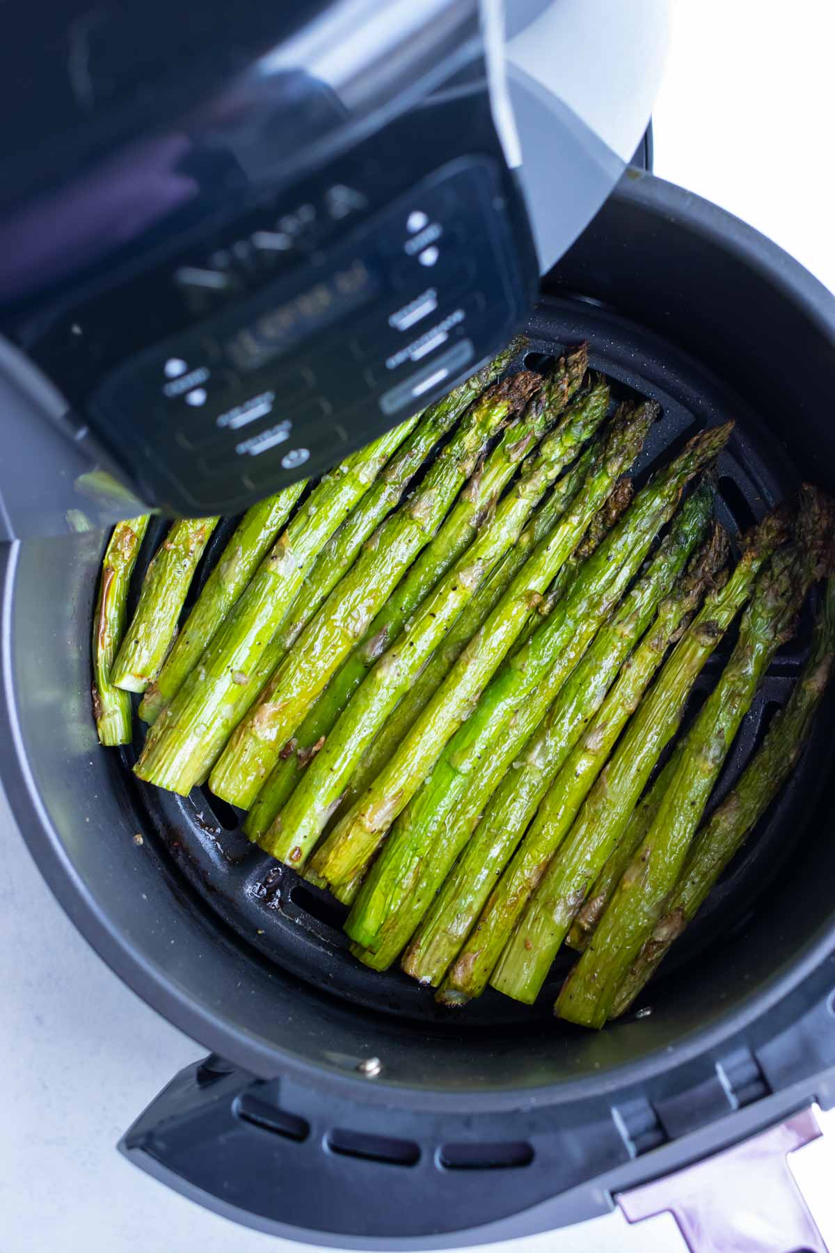 Easy asparagus is cooked in a Ninja air fryer.