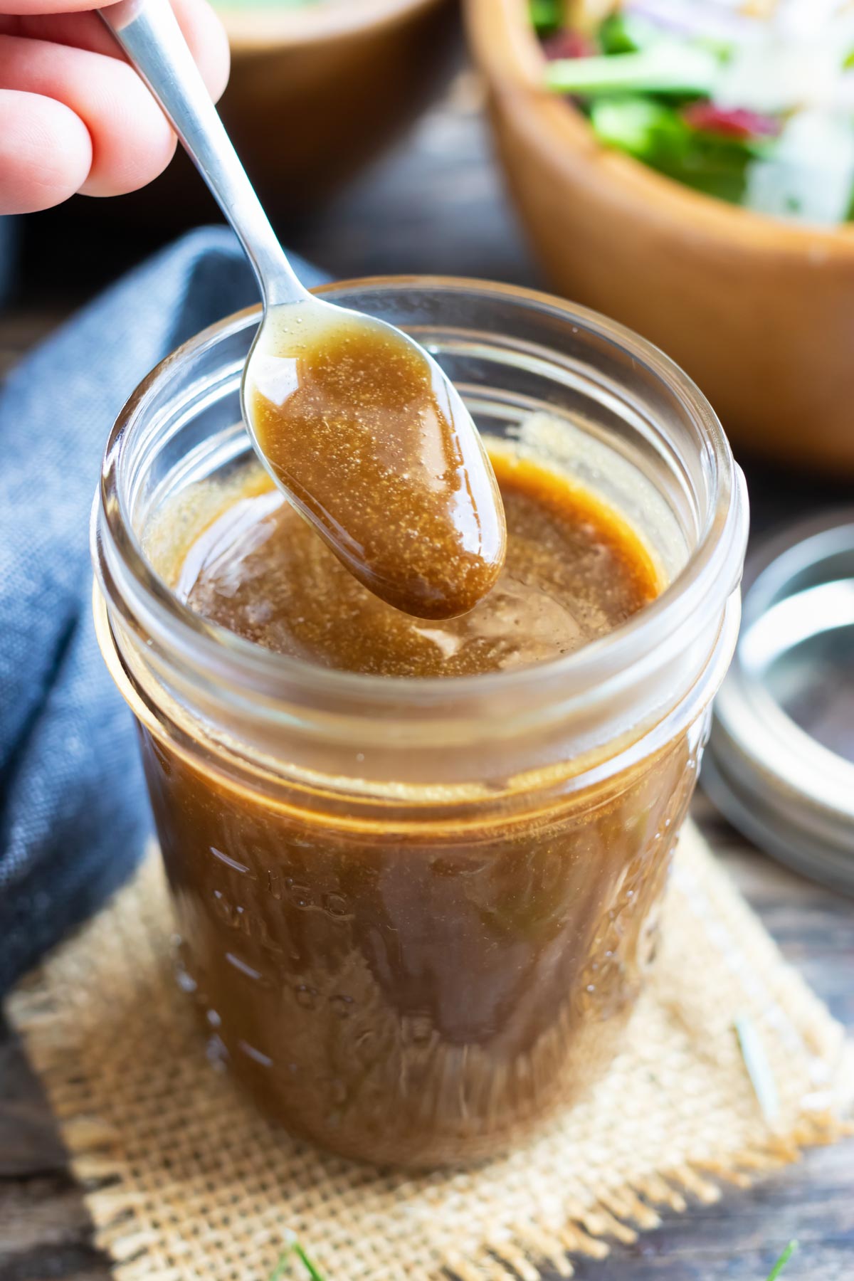Healthy Balsamic Vinaigrette Dressing RECIPE served in a Mason jar with a spoon.