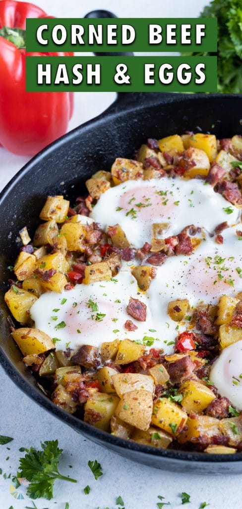 Healthy corned beef hash and eggs are made in a cast-iron skillet for breakfast.