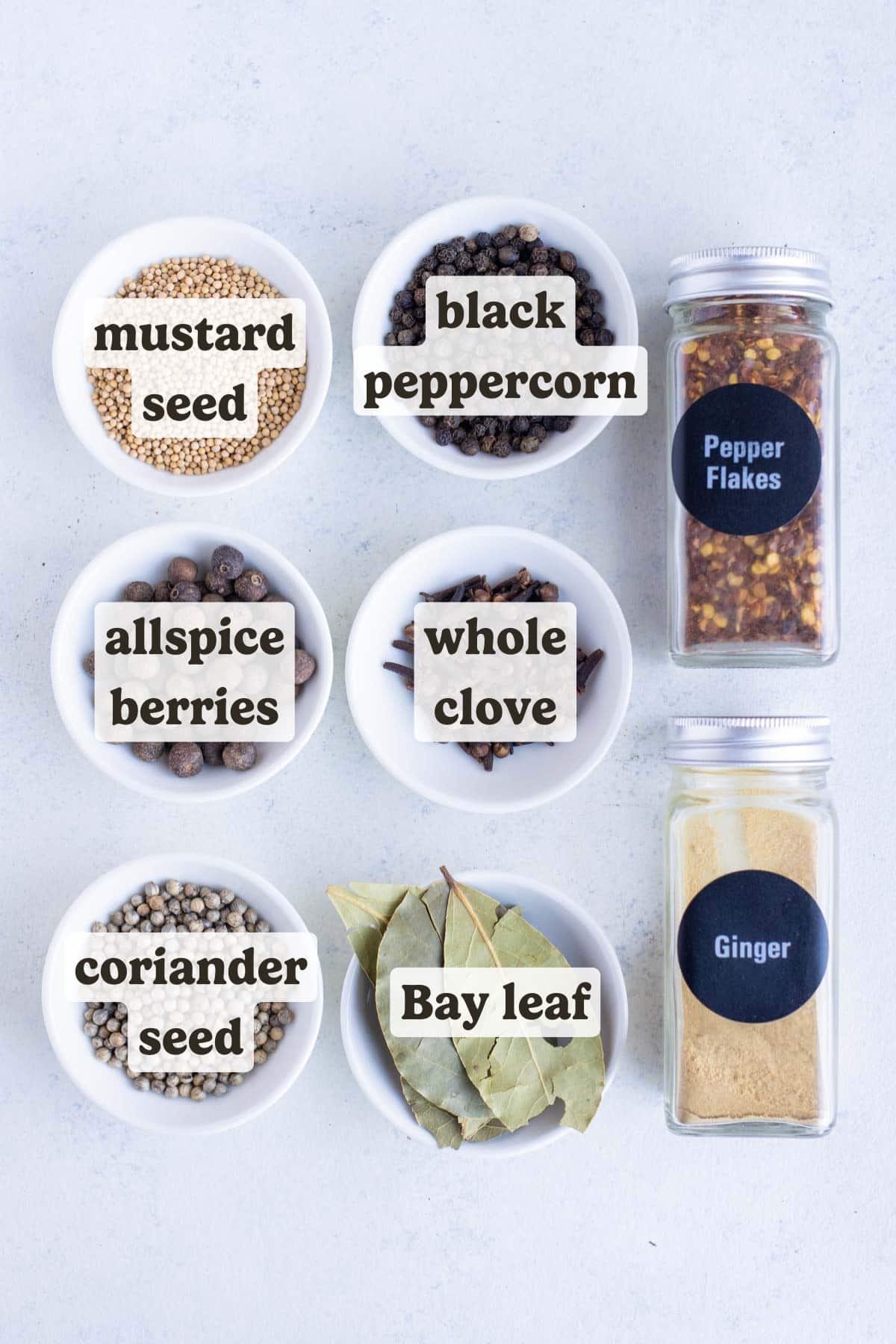 Black peppercorns, yellow mustard seeds. coriander seeds, bay leaves, red pepper flakes, whole cloves, ground ginger, allspice berries, and dill seed are the ingredients for this recipe.