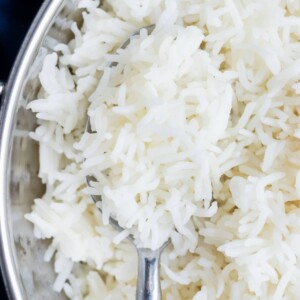 A spoon is scooping out a bite of basmati rice that was cooked in the Instant Pot.