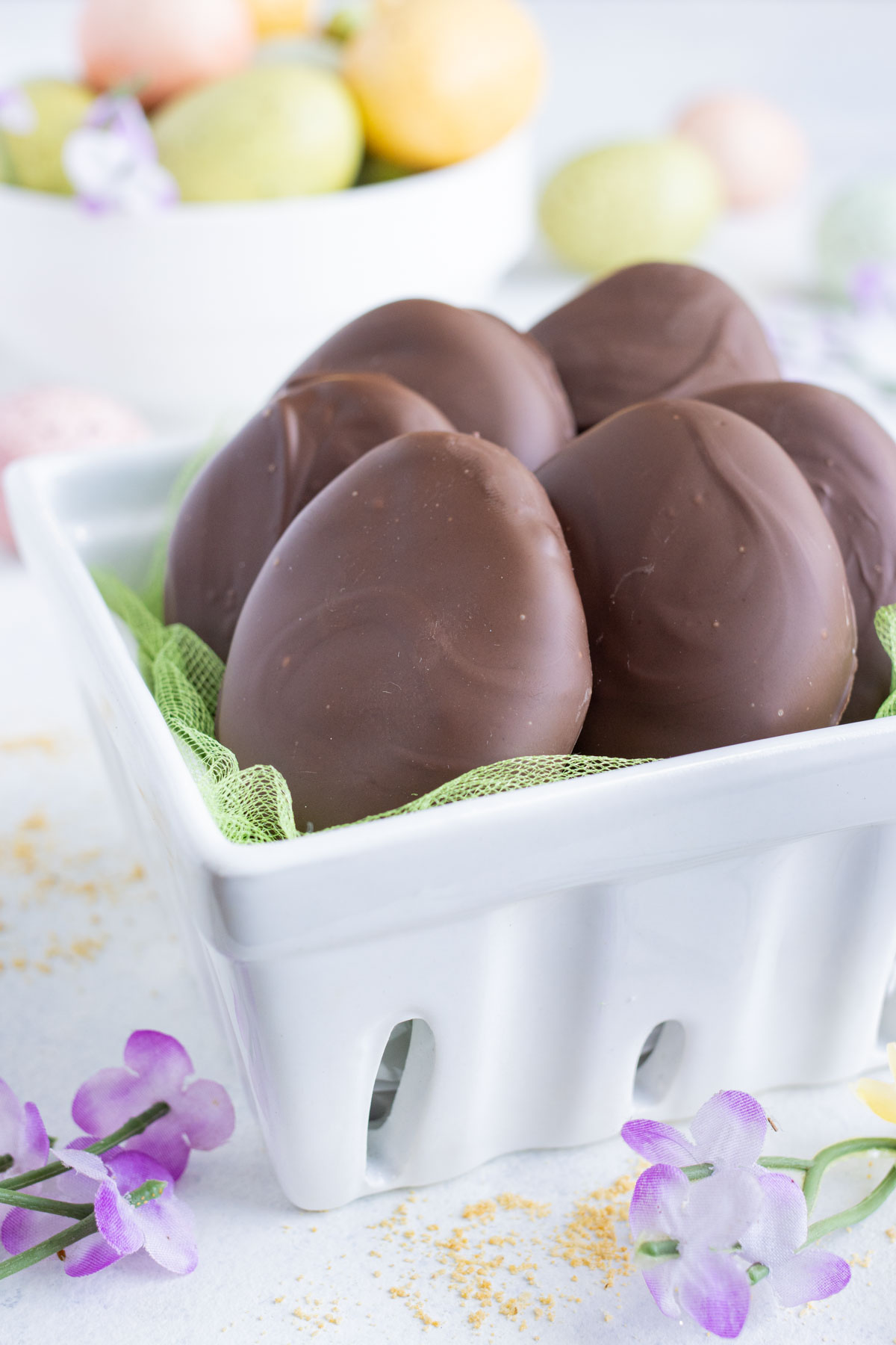 Copycat Reese's peanut butter eggs are held in a basket.