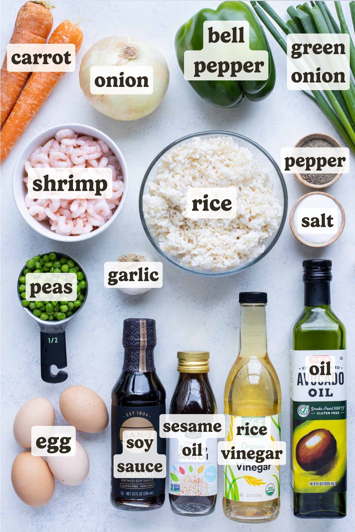 Shrimp, rice, peas, ball peppers, carrots, onion, garlic, egg, seasonings, green onions, oil, rice vinegar, and soy sauce are the ingredients for this shrimp fried rice.