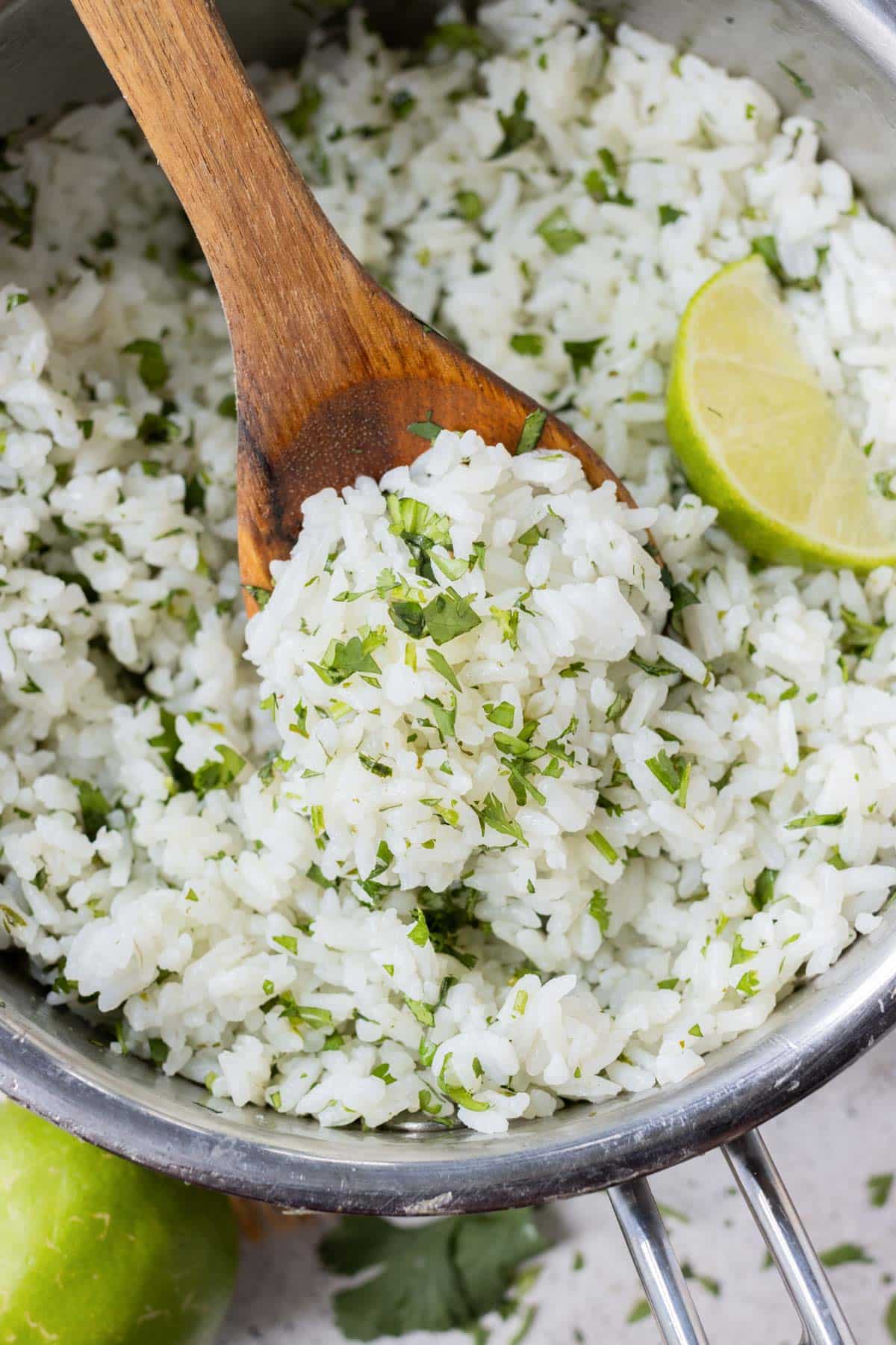 Cilantro Lime Rice Recipe (Chipotle Copycat) RECIPE served in a silver pot with a wooden spoon.