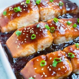 The cooked teriyaki salmon is toped with fresh green onions and sesame seeds.
