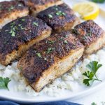 Blackened mahi mahi is served on top of white rice for dinner.