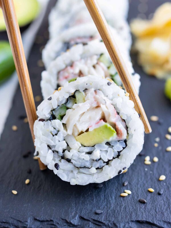 Chopsticks are used to eat sushi rolls.