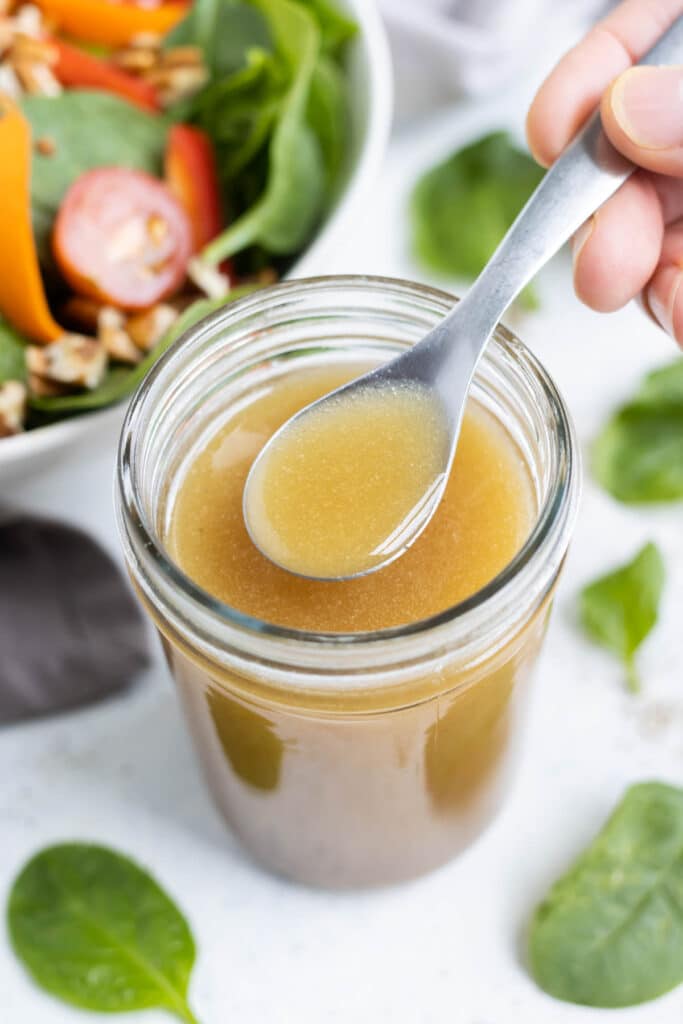 A jar full of apple cider vinaigrette.