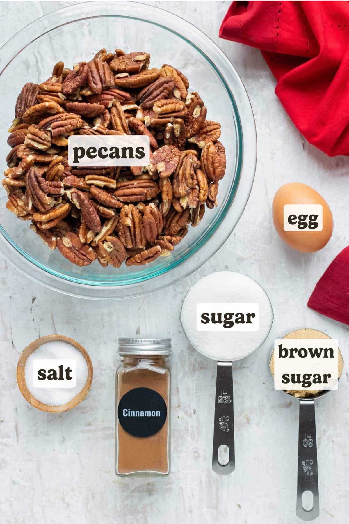 Pecans, cinnamon, sugar, and an egg as the ingredients for an easy, gluten-free candied pecans recipe.