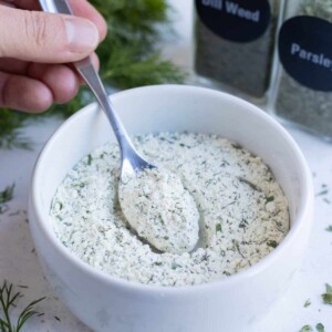 A spoonful of homemade ranch seasoning in a white ramekin.