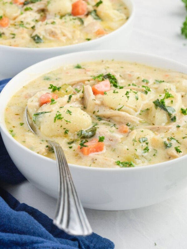 Olive Garden's Chicken Gnocchi Soup in a white bowl with a spoon.