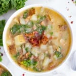 A bowl full of Olive Garden's Zuppa Toscana Soup made with a copycat recipe in a white bowl.