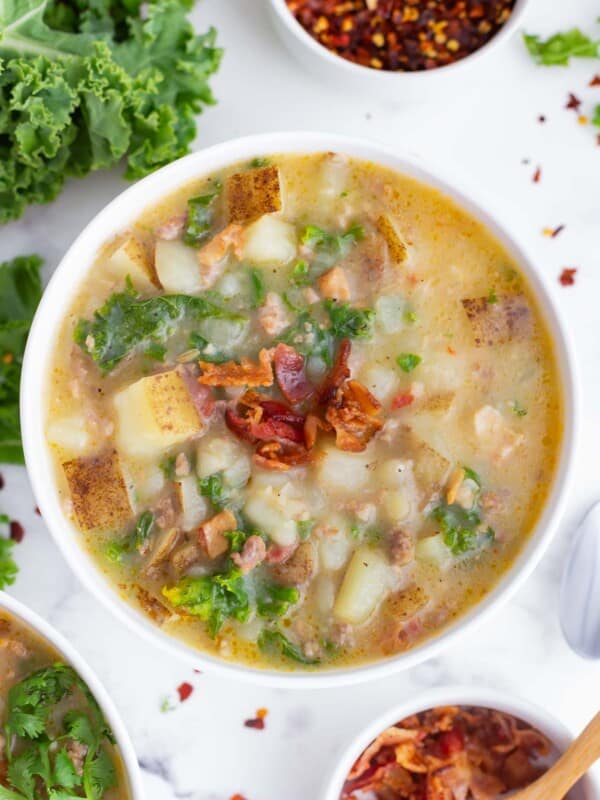 A bowl full of Olive Garden's Zuppa Toscana Soup made with a copycat recipe in a white bowl.