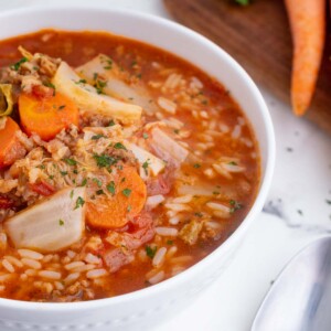 Warm and hearty cabbage roll soup is cooked in a Dutch oven.