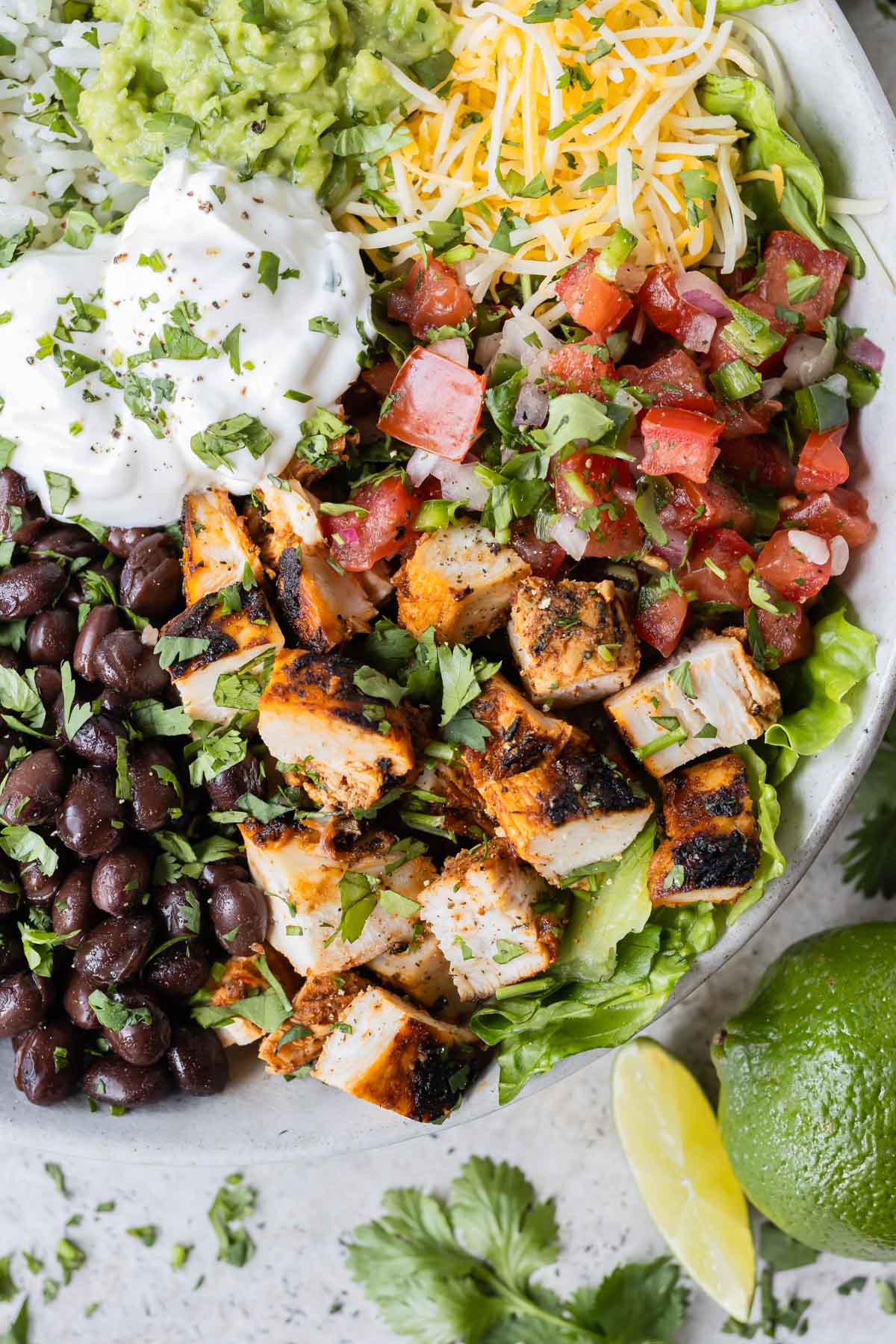 Chipotle chicken is cut into cubes and served in a burrito bowl for a copycat recipe.