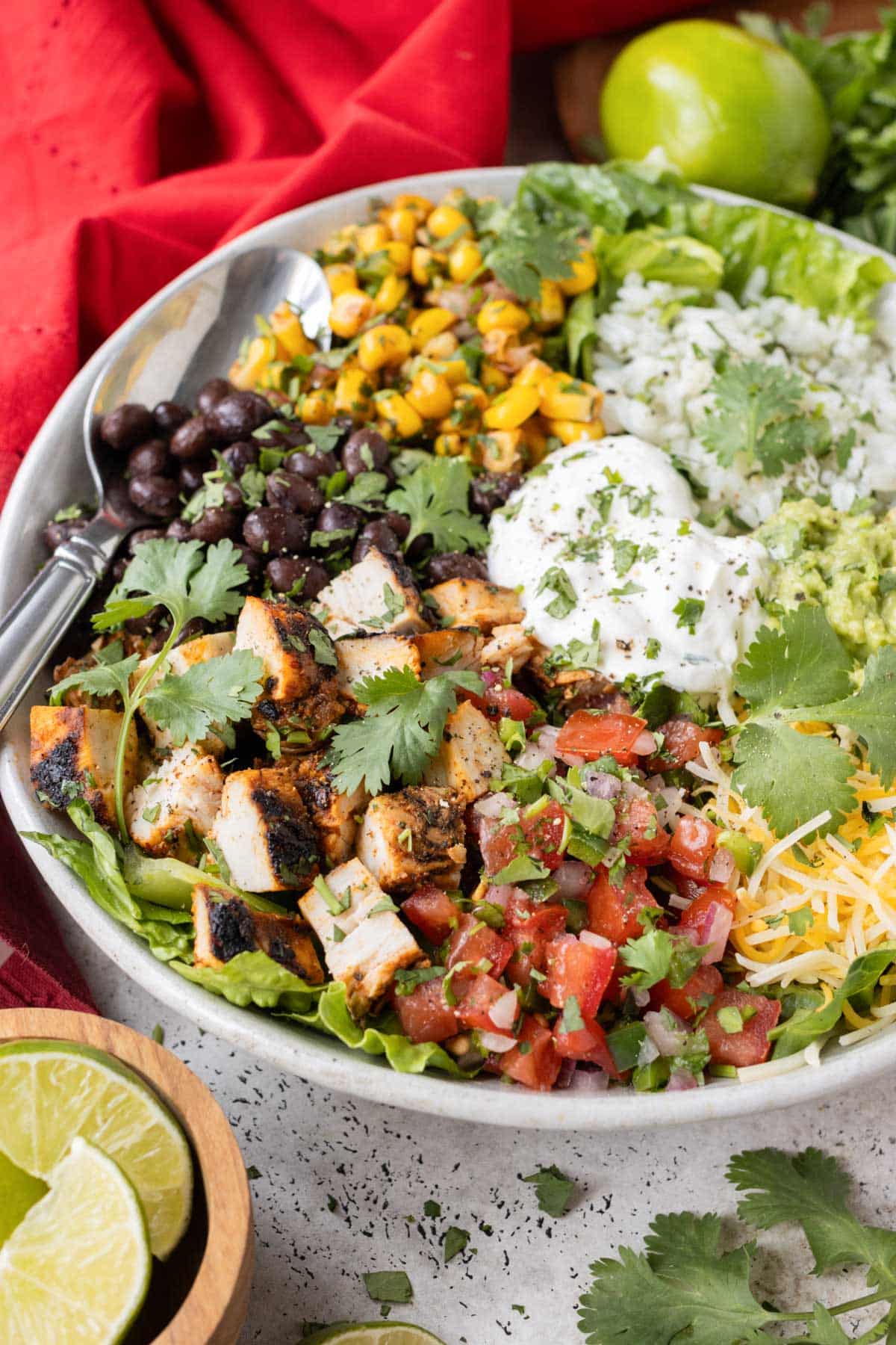 A Chipotle burrito bowl recipe is full of cilantro lime rice, chipotle chicken, guacamole, and corn salsa.