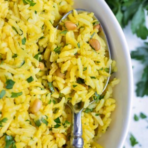 Mediterranean rice is served with a metal spoon.
