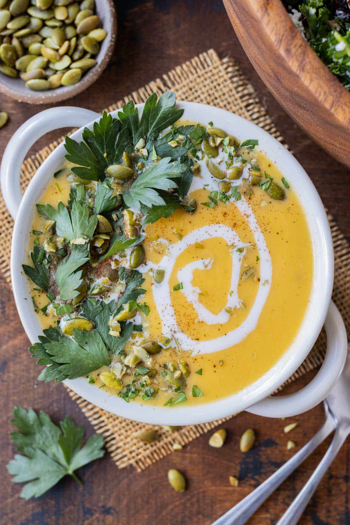 Roasted Butternut Squash Soup with Coconut Milk RECIPE served in a white soup bowl with green garish