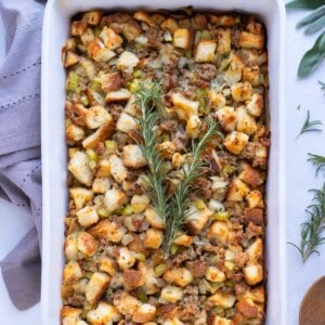 Sausage stuffing is served with fresh herbs and served at Thanksgiving.