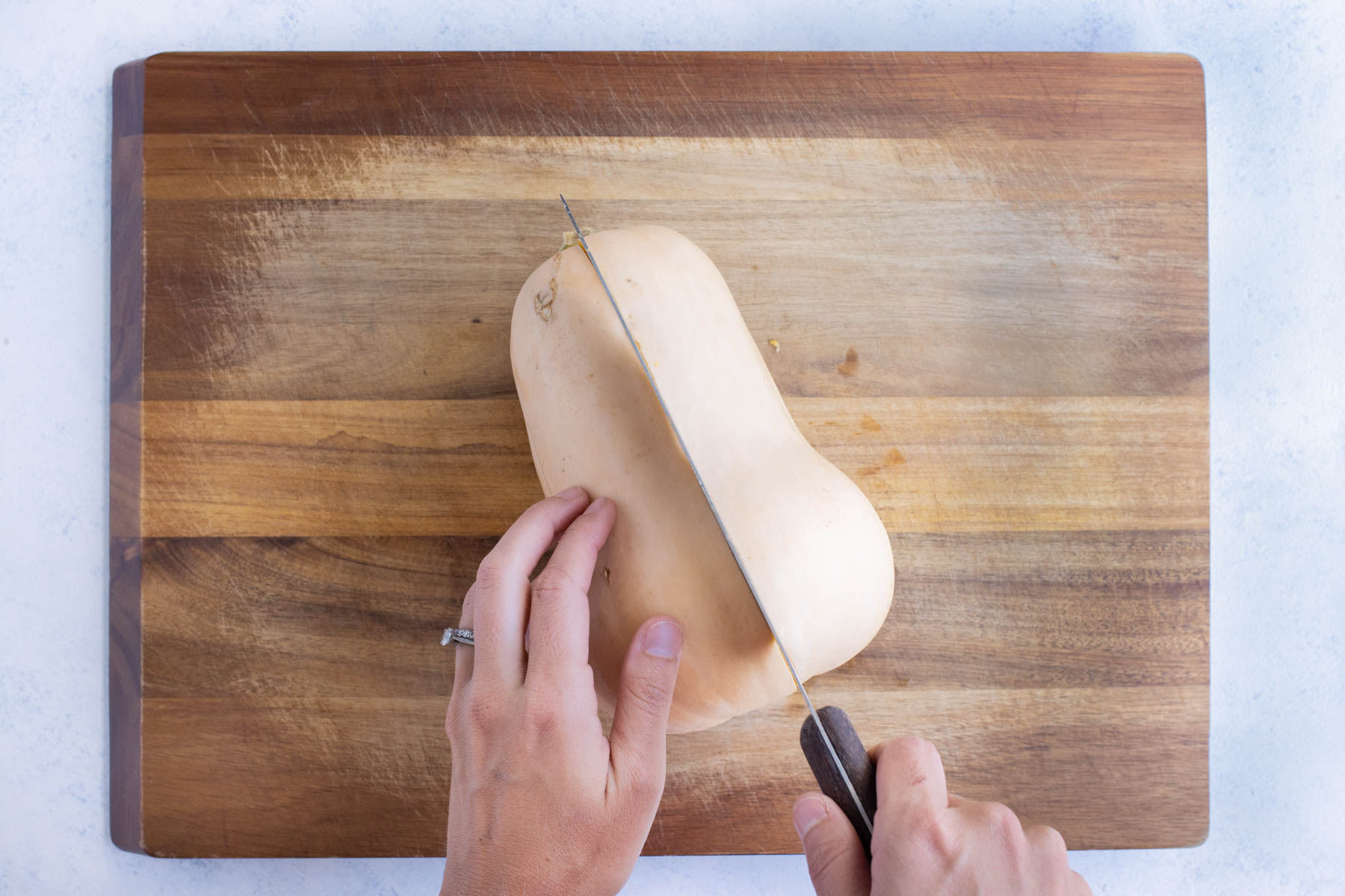 A large butternut squash is cut in half.