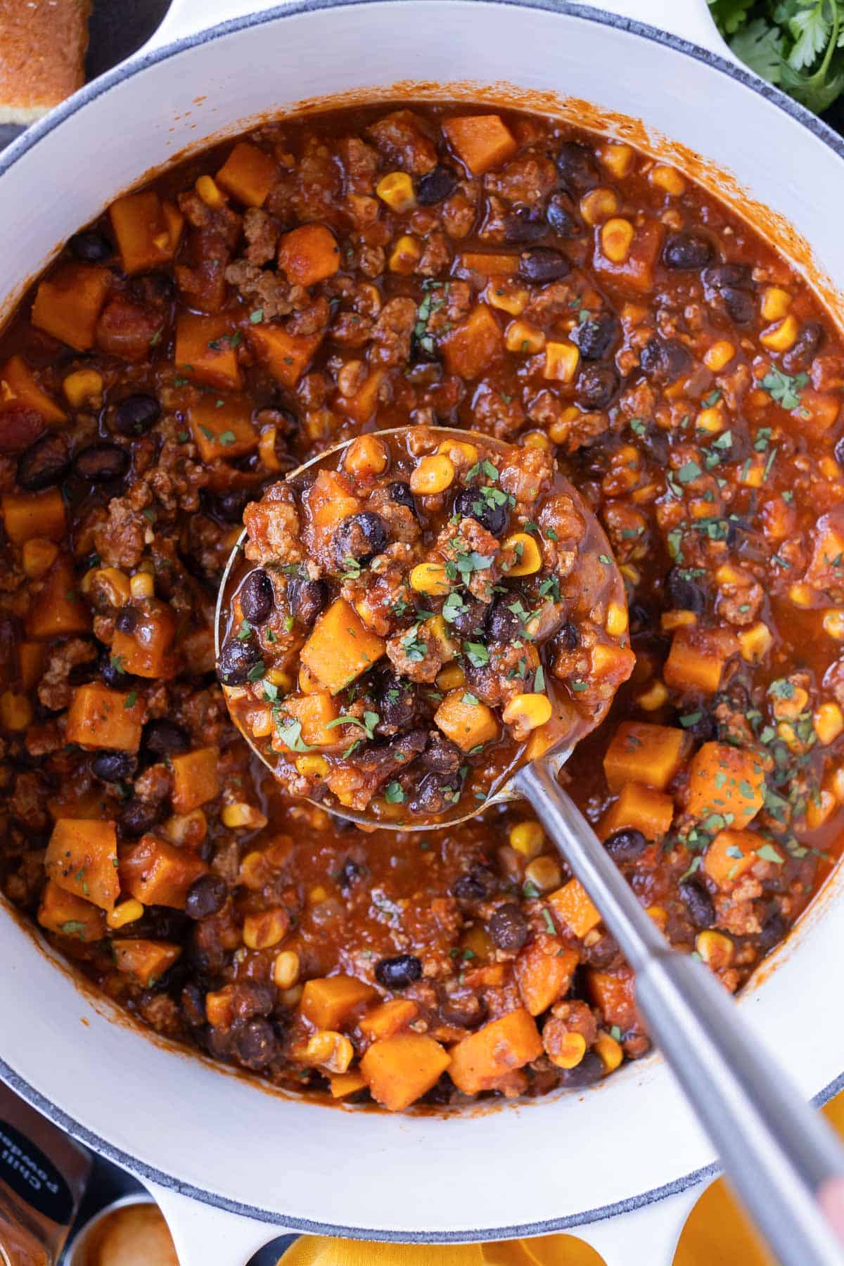 Sweet potato turkey chili is cooked in a Dutch oven on the stovetop.