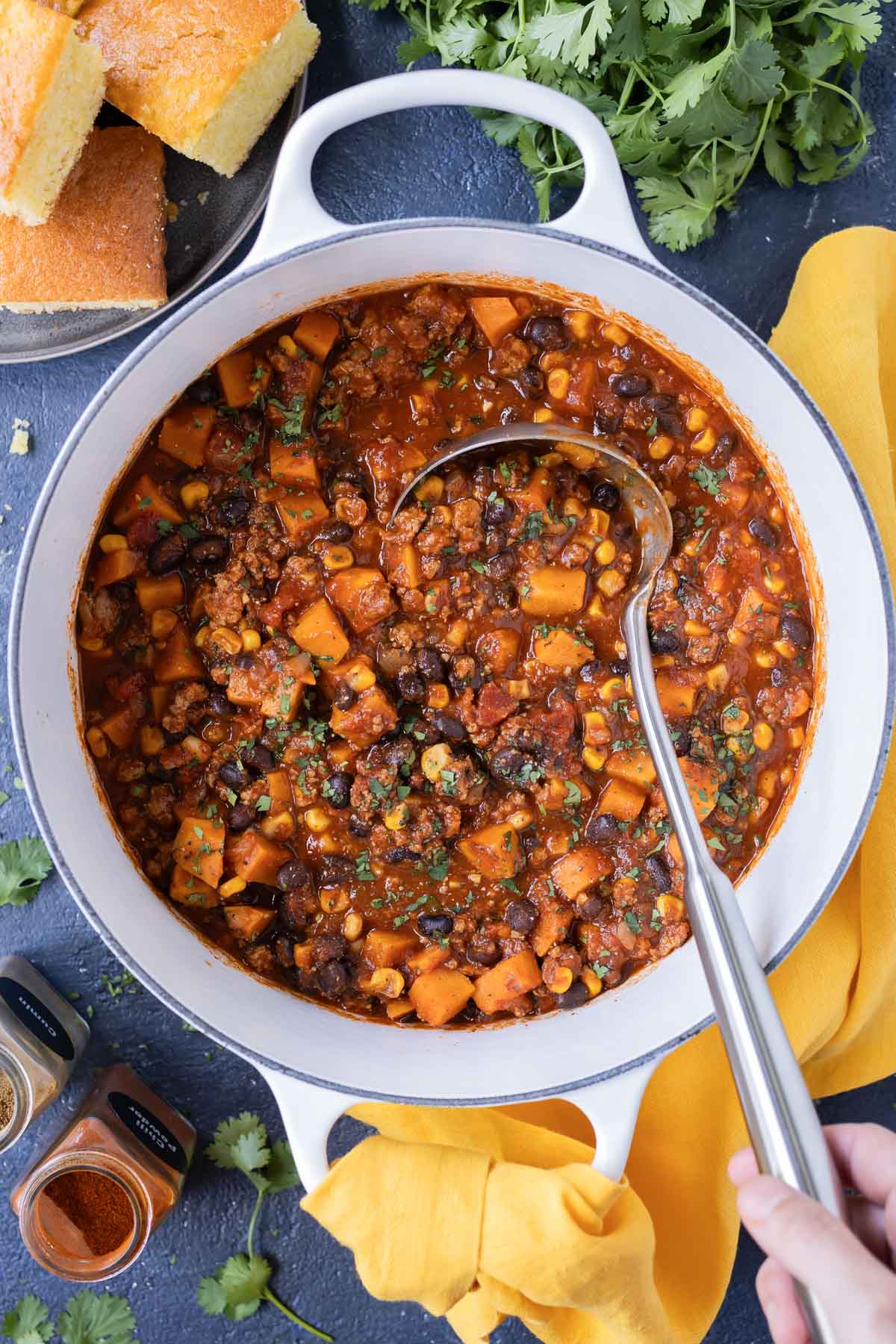 Sweet potato turkey chili is cooked in a Dutch oven on the stovetop.