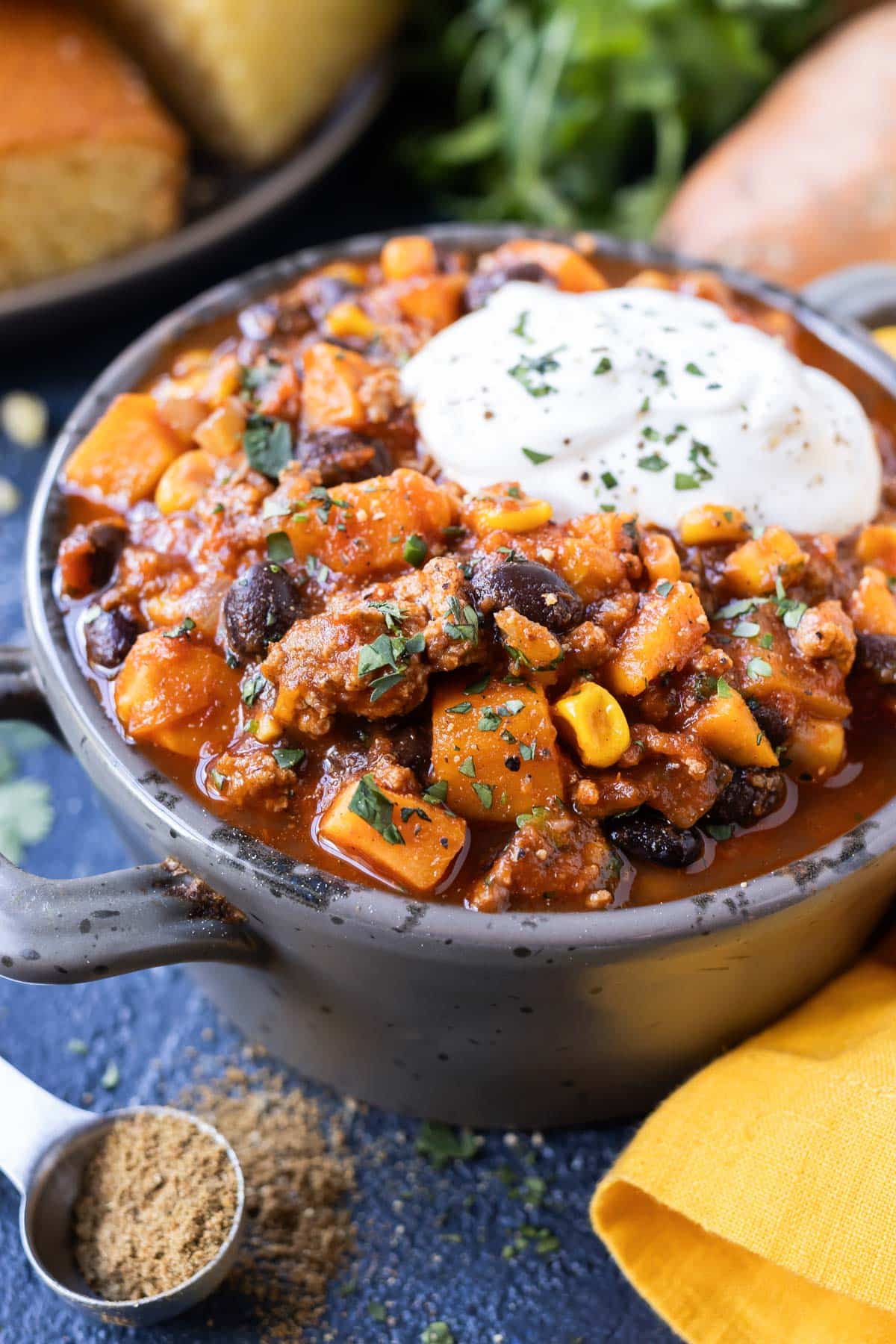 A ground turkey chili recipe served in a bowl with sour cream.