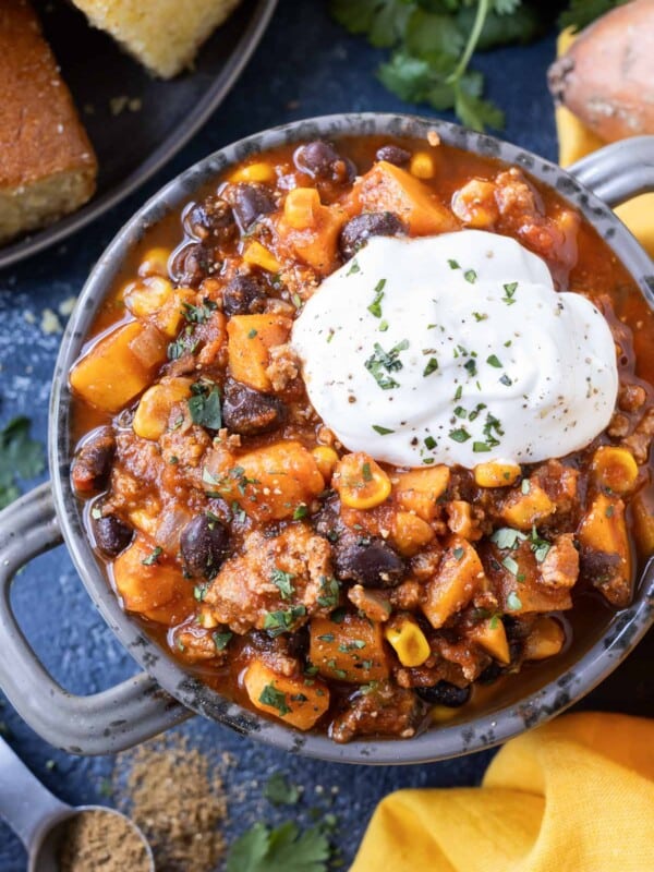 Sweet potato turkey chili is served in a bowl with sour cream.