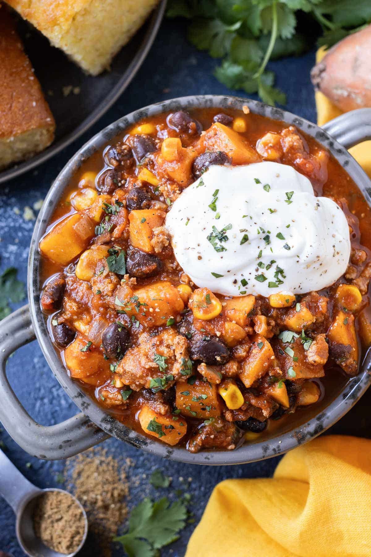 Sweet potato turkey chili is served in a bowl with sour cream.