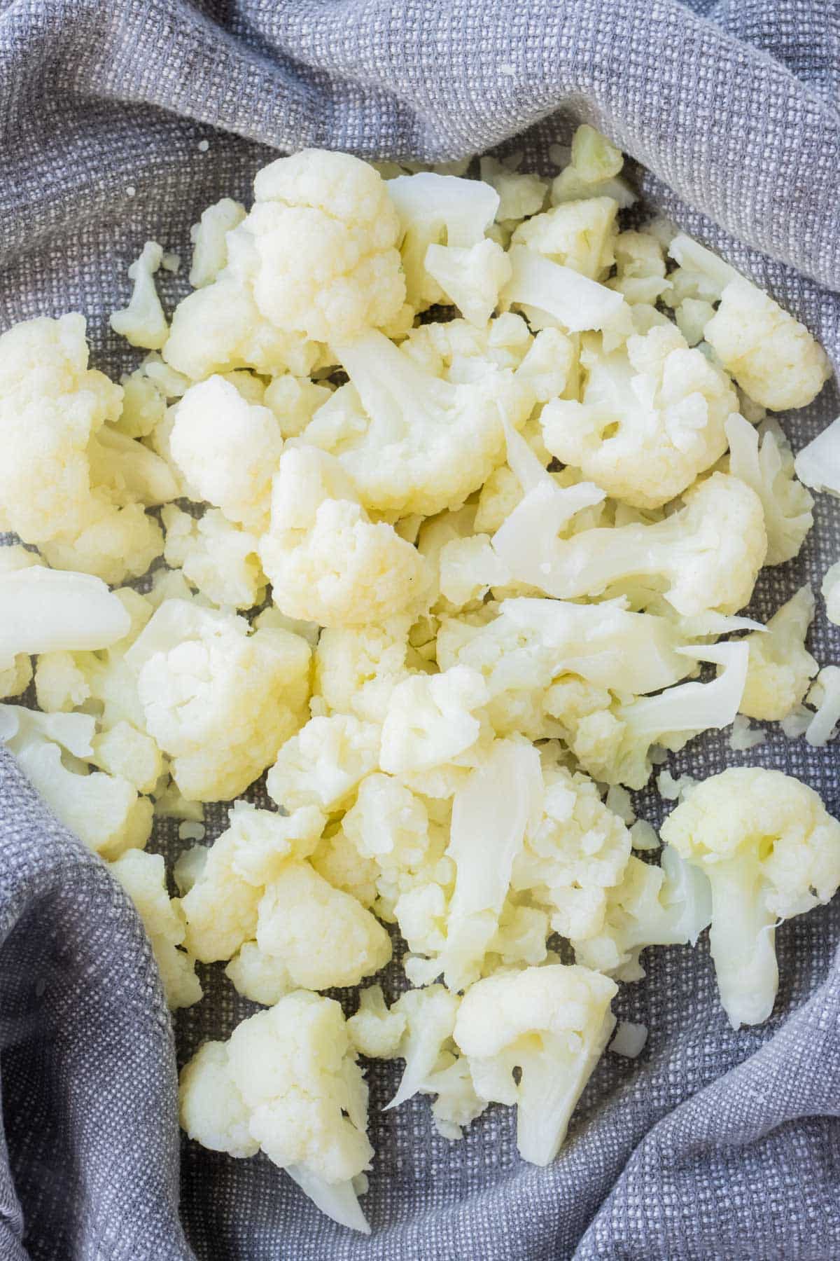 Cooked cauliflower is dried in a towel.