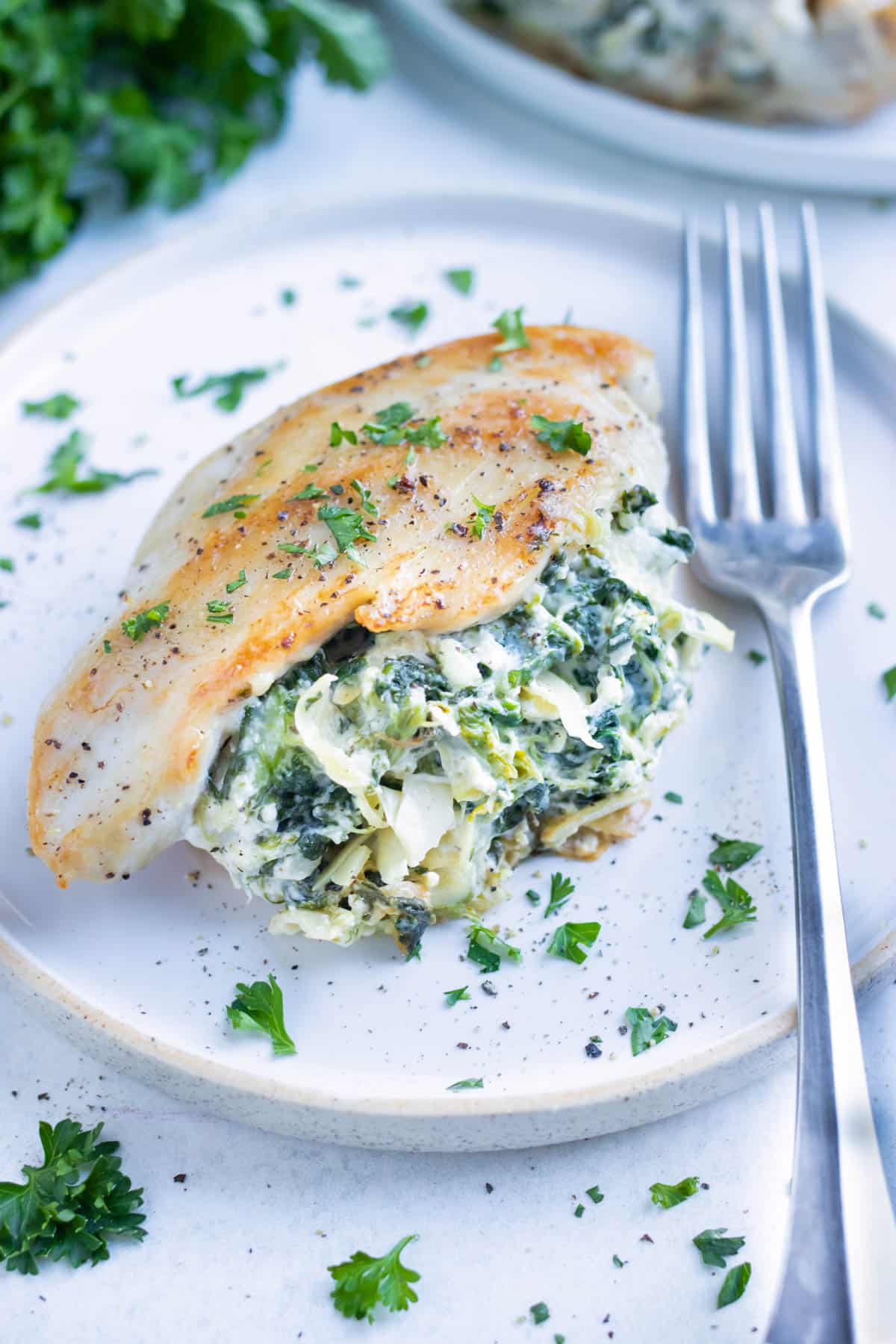 Stuffed chicken breast is plated for an easy, low-carb dinner.