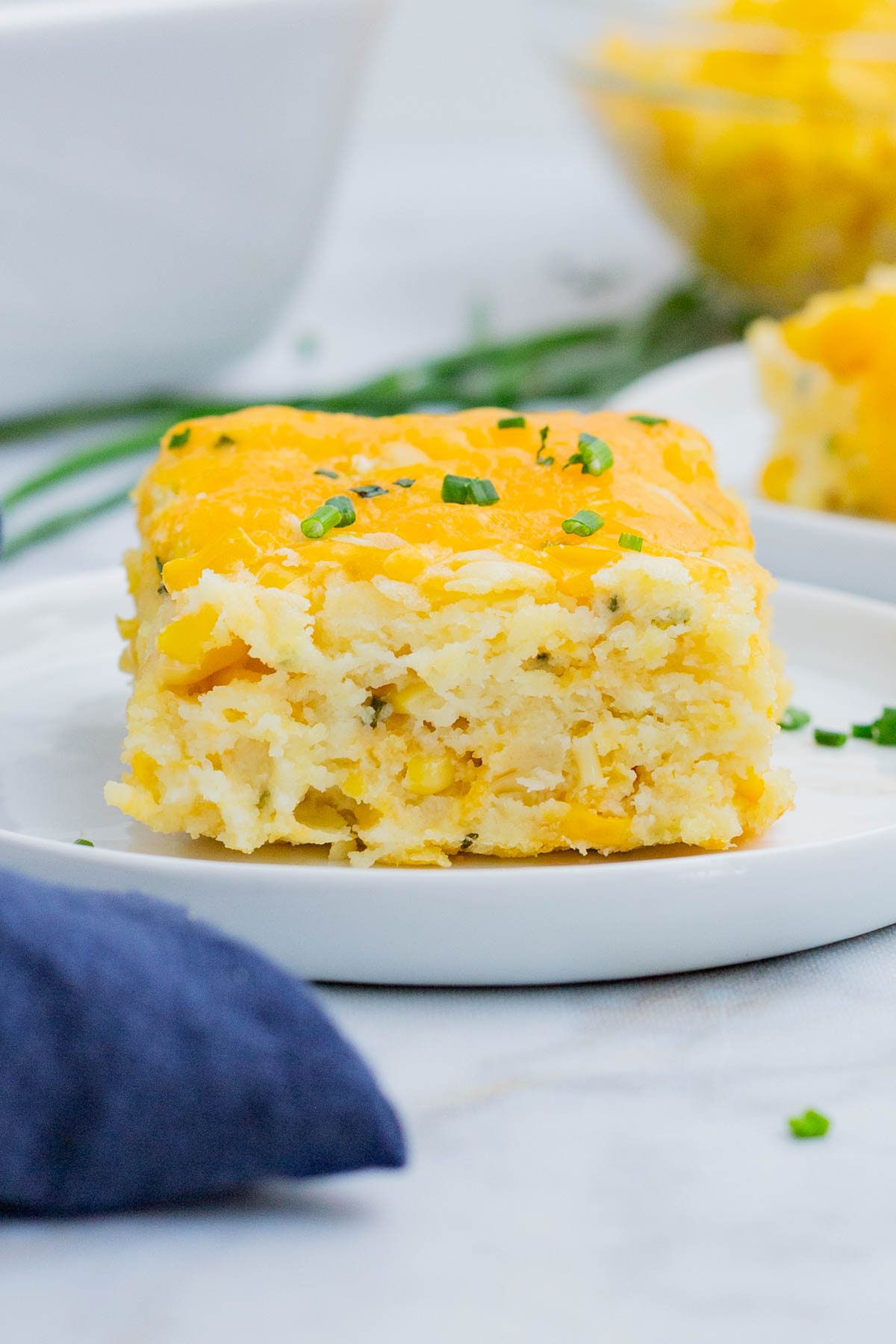 Two plates with corn souffle are served at a Holiday dinner.