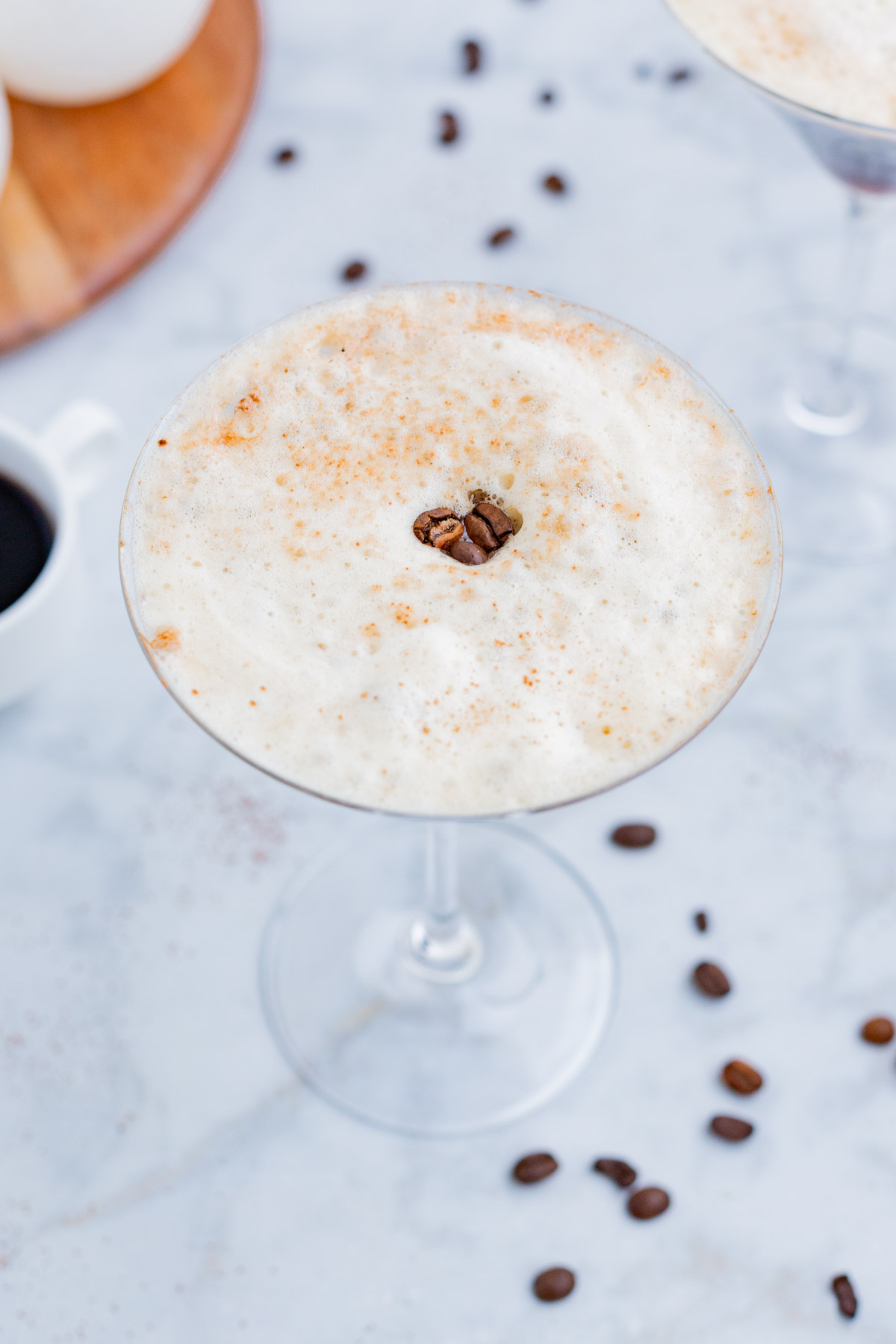 Coffee beans garnish the top of an espresso martini.