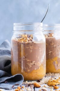 Two glass jars filled with gluten-free Healthy Chocolate Peanut Butter Overnight Oats.