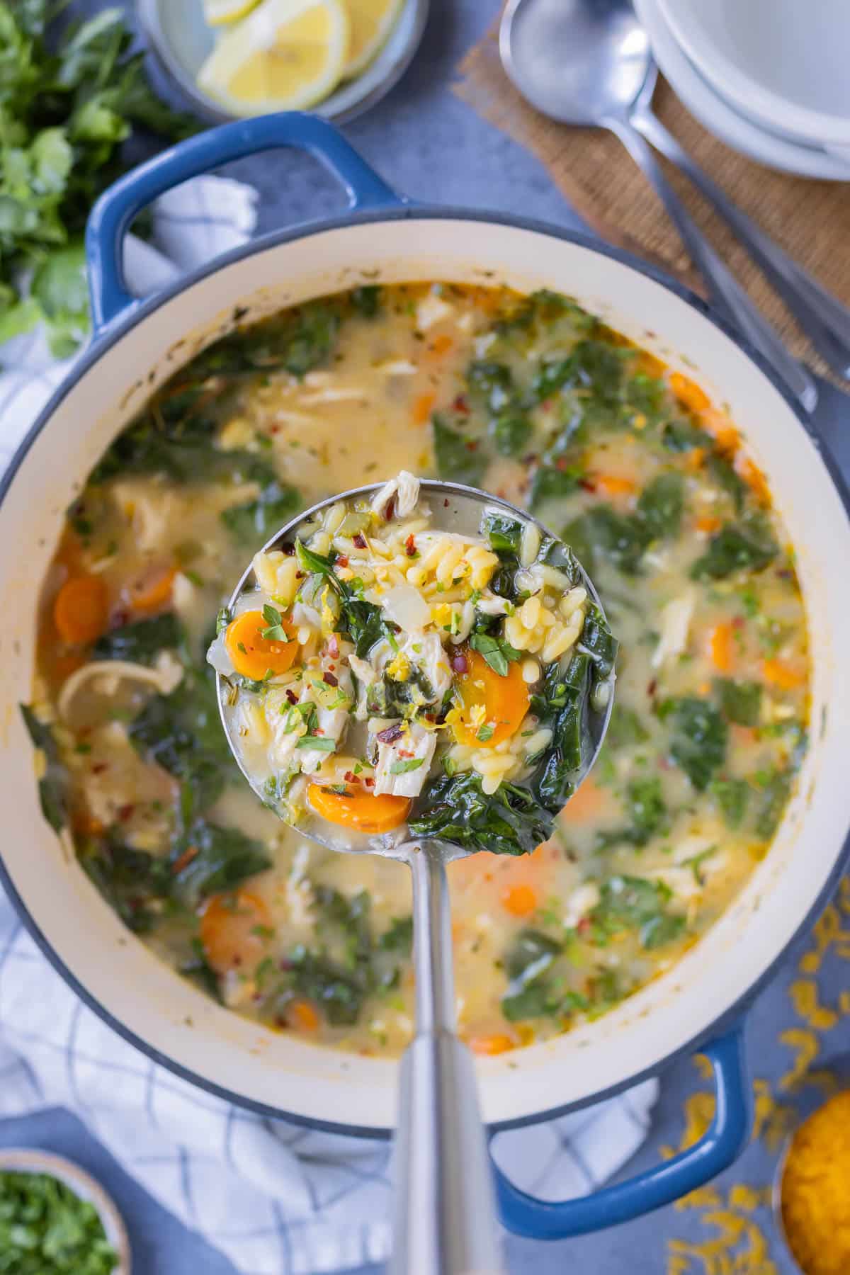 Lemon Chicken Orzo Soup is cooked in a large Dutch oven.