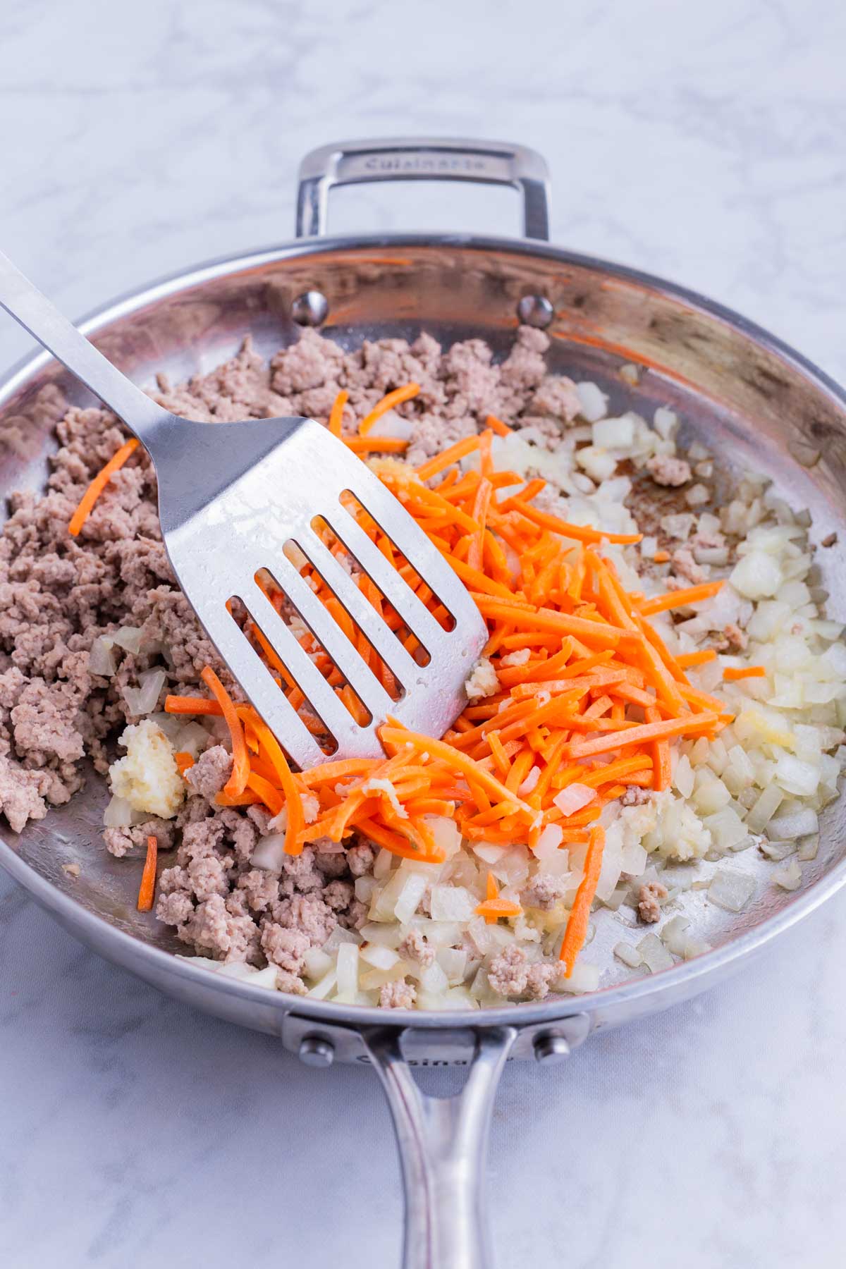 Carrots are stirred into the meat mixture.