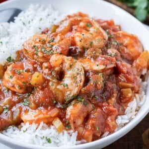 An authentic Shrimp Creole recipe is served in a bowl with white rice.