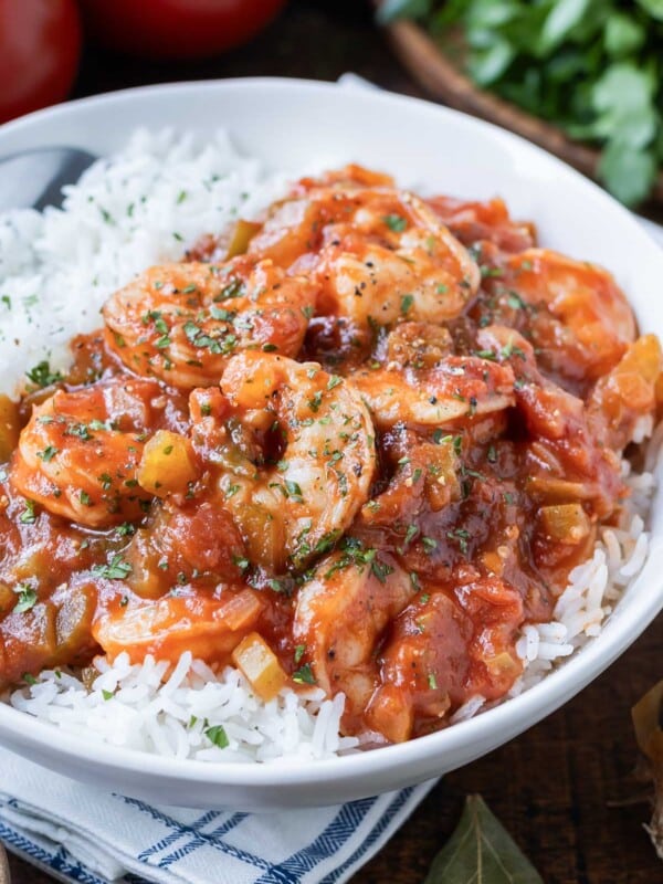 An authentic Shrimp Creole recipe is served in a bowl with white rice.