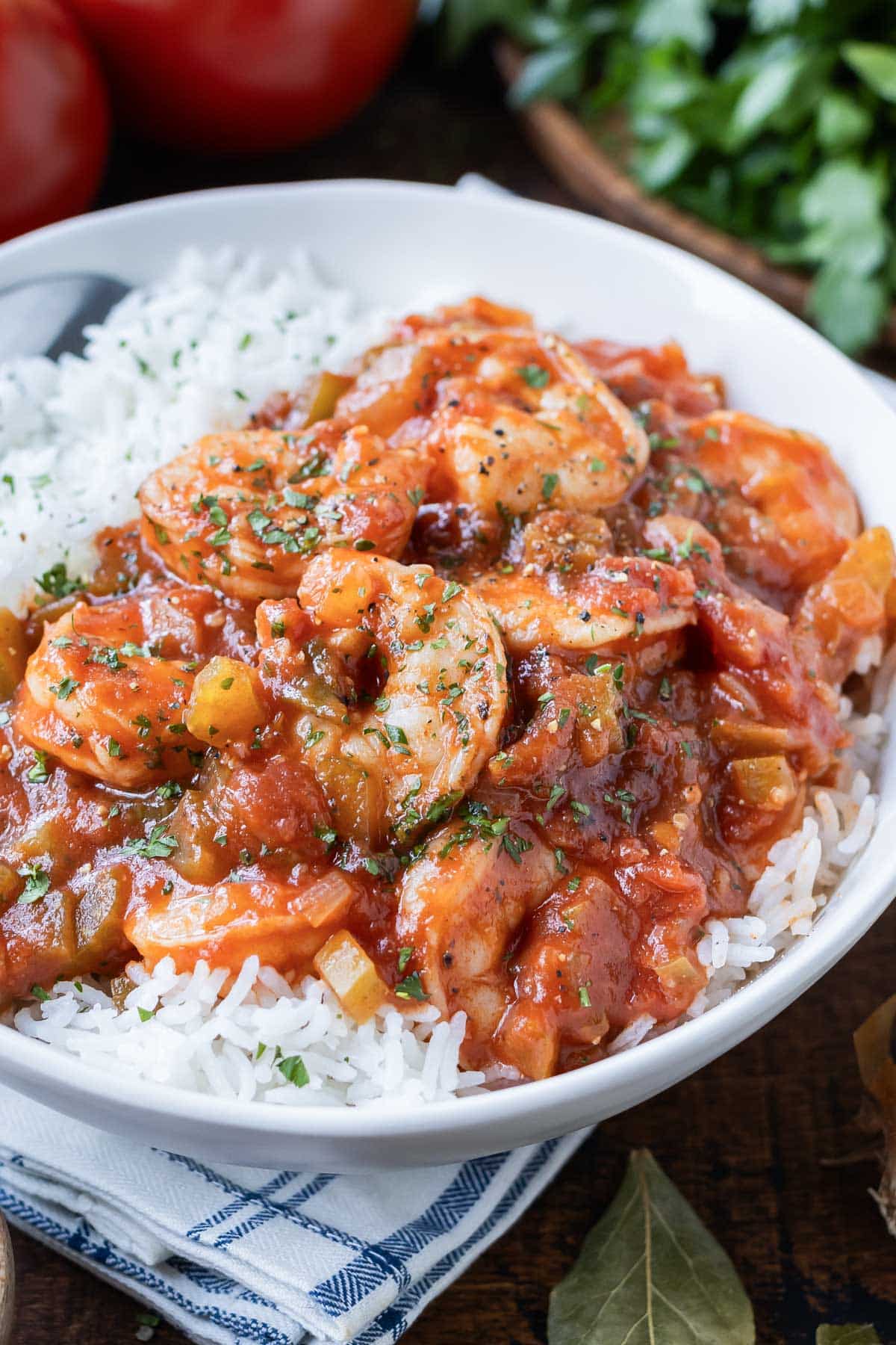 An authentic Shrimp Creole recipe is served in a bowl with white rice.