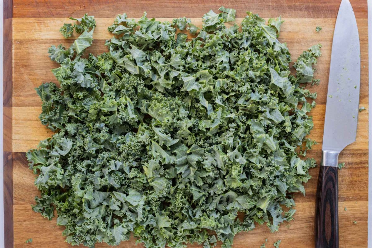 Chopped kale is on a cutting board for a Fall salad.