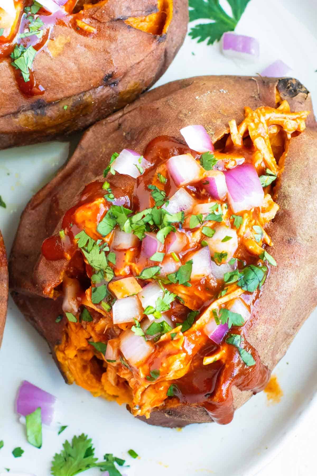 Easy BBQ Chicken Stuffed Sweet Potatoes on a white plate.