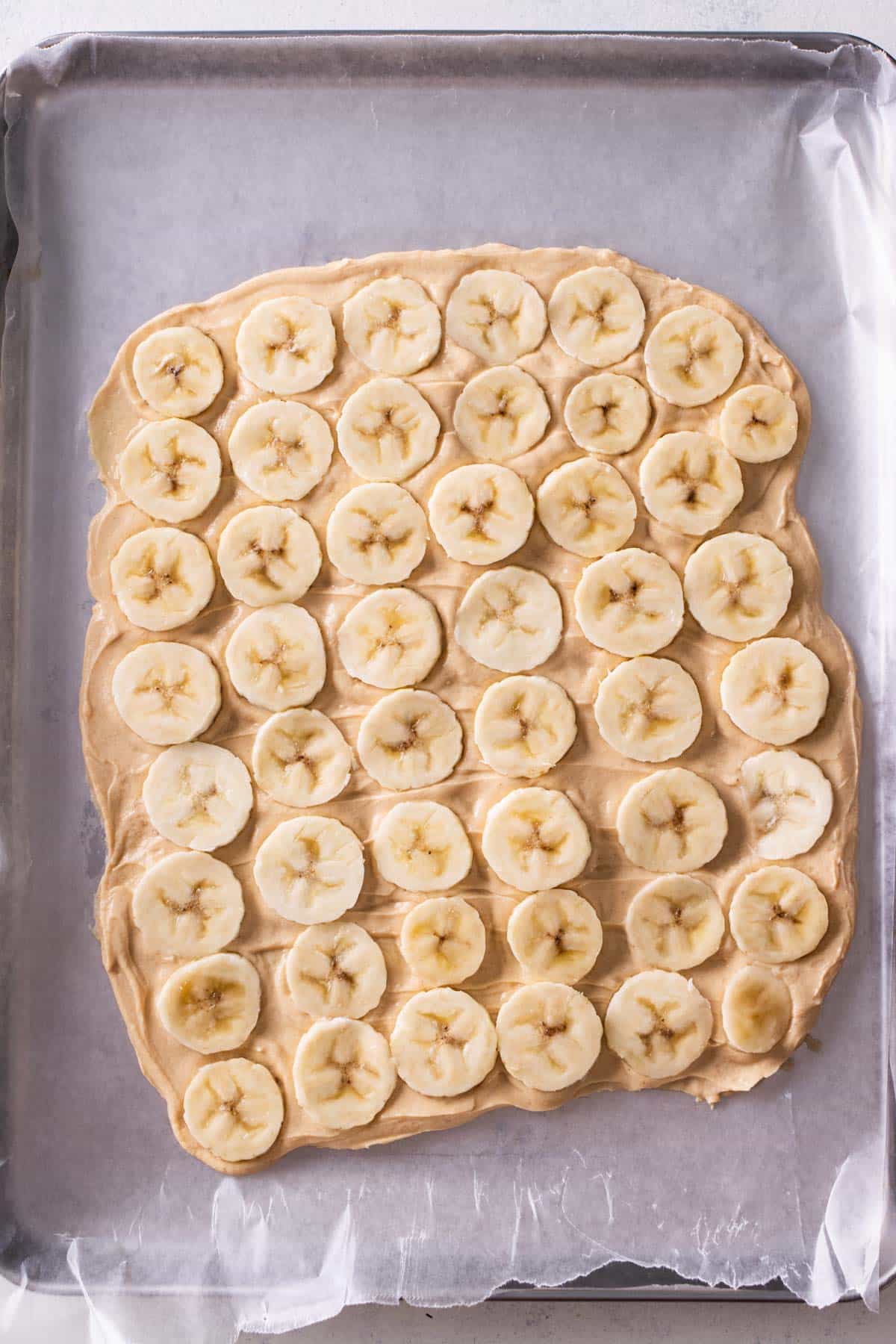 Bananas are spread across peanut butter-flavored yogurt.