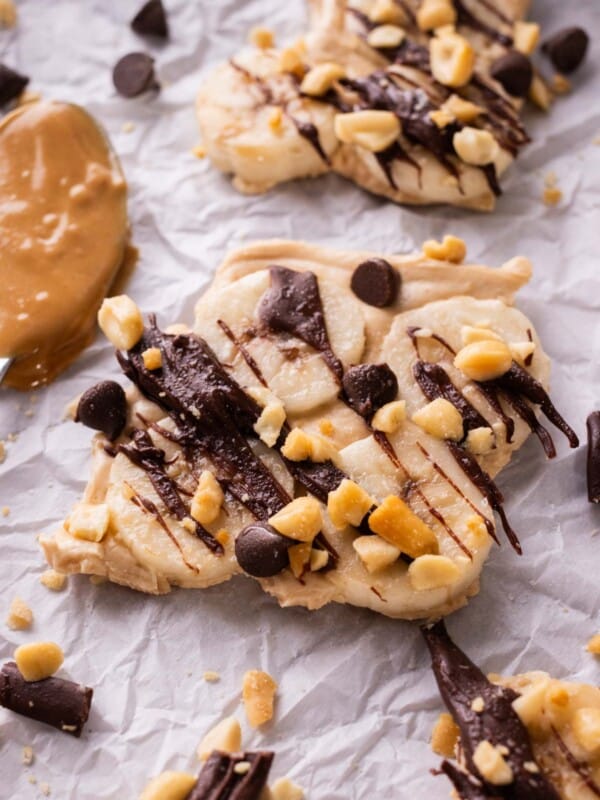 Pieces of chunky monkey frozen yogurt bark are spread on a tray.