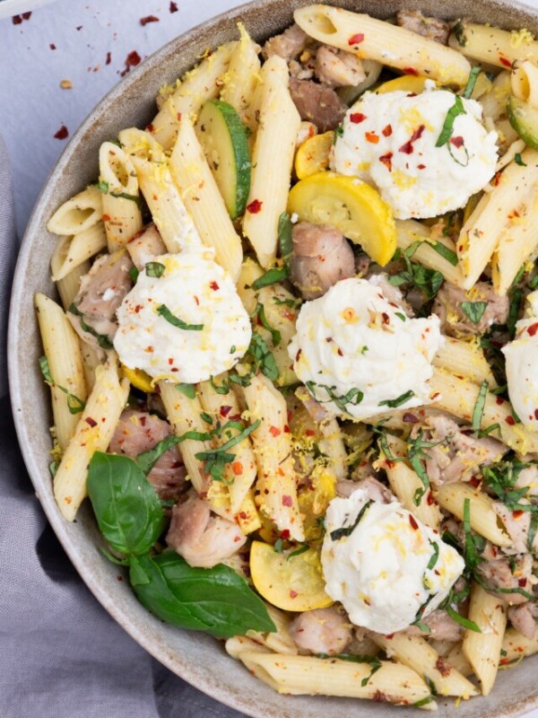 Pasta, veggies, and chicken are tossed with a lemon butter sauce and topped with ricotta cheese.